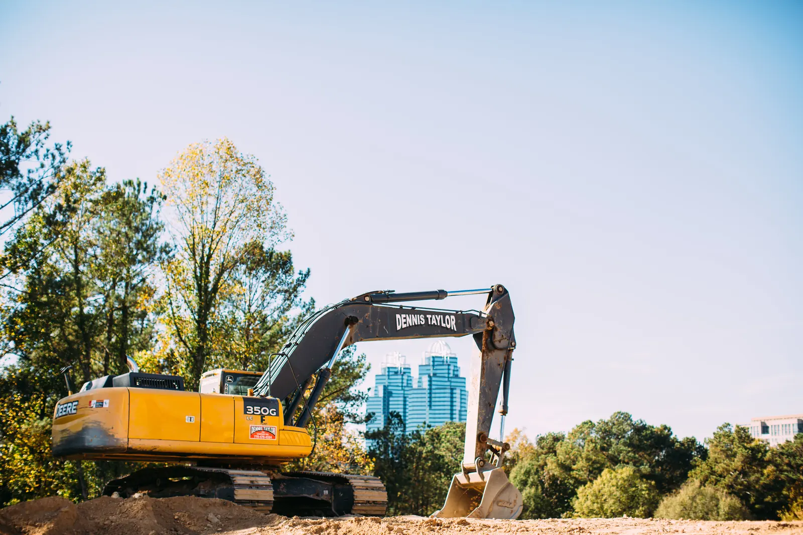 Dennis Taylor 350G excavator with the Atlanta skyline behind it